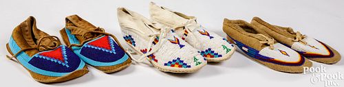 Three pairs of beaded moccasins