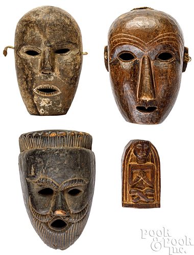 Three carved Nepalese masks