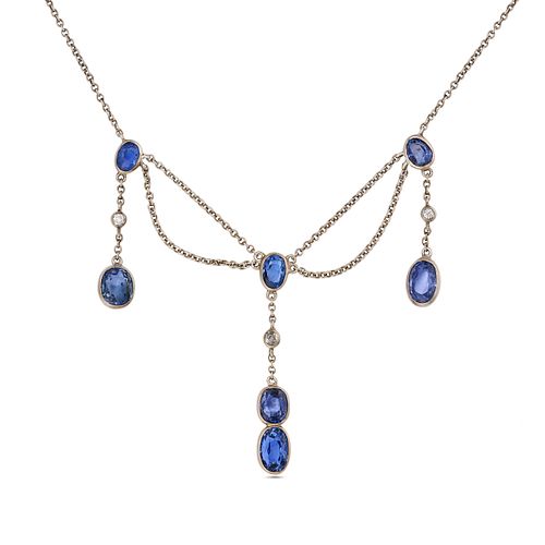 A SAPPHIRE AND DIAMOND FRINGE NECKLACE in platinum, comprising a trace chain set with oval cut sa...