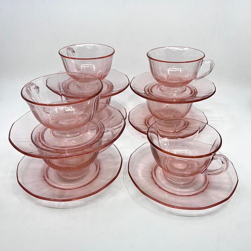 Seven Pink depression glass style cups and saucers