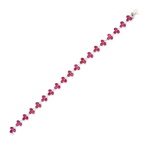 A RUBY AND DIAMOND BRACELET in 18ct white gold, set with nineteen clusters of oval cut rubies acc...