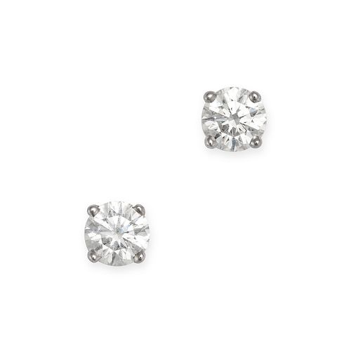 TIFFANY AND CO., A PAIR OF SOLITAIRE DIAMOND STUD EARRINGS in platinum, each set with a round bri...