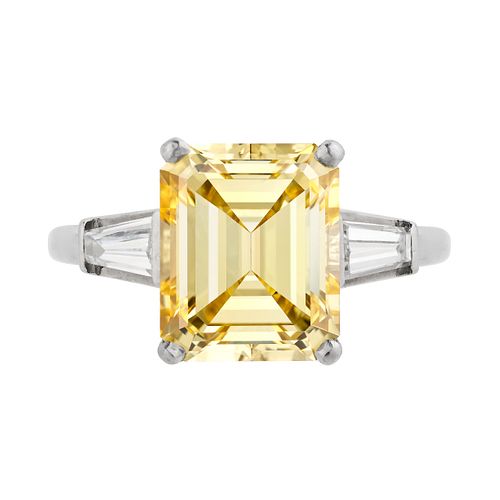 A 5.46 CARAT FANCY INTENSE YELLOW DIAMOND RING in platinum, set with an emerald cut yellow diamon...