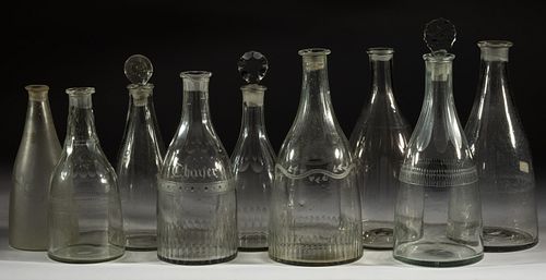 ASSORTED FREE-BLOWN PRUSSIAN-FORM DECANTERS, LOT OF NINE