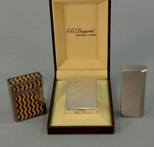 Three lighters including St. Dupont silver lighter brand new in box marked St Dupont Paris made in France 65ONL73, a Cartier 