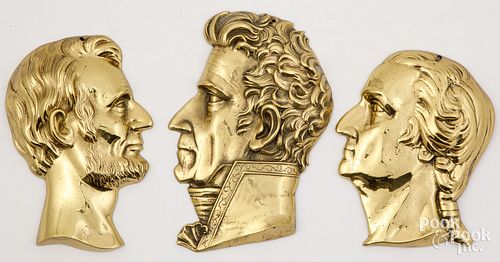 Three brass profile plaques