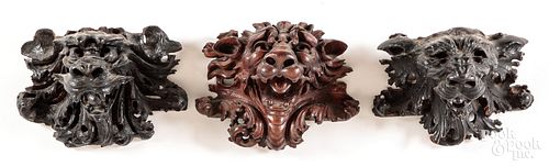 Three carved lion head wall plaques, ca. 1900