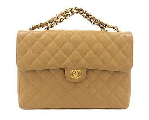 A Chanel Beige Caviar Leather Jumbo Flap Bag, 12 1/2 x 8 1/2 x 3 1/2 inches.