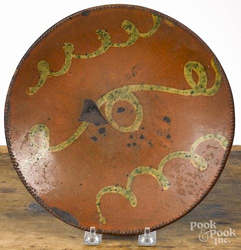 Redware plate, 19th c., with yellow and green slip decoration, 9 1/2'' dia.