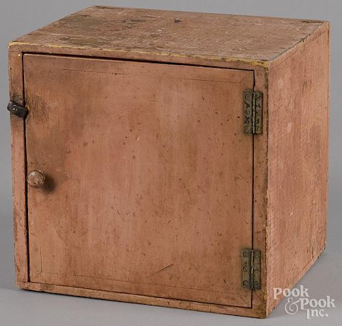 Small painted pine table top cupboard in salmon paint, 11 1/4'' h., 11 3/4'' w.
