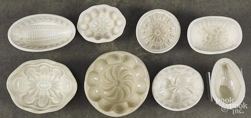 Eight ironstone food molds, to include a bird, cherries, corn, etc. largest - 4 1/2'' dia.