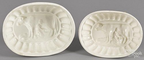 Two ironstone food molds with a man milking a cow, 2 1/2'' h., 7'' w. and 3 1/2'' h., 8'' w.