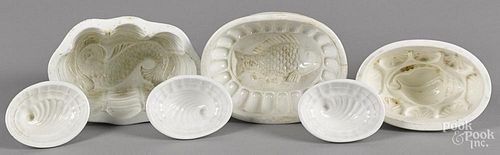 Six ironstone food molds, to include fish, dolphin, and four shells, largest - 4 1/4'' h., 6 1/2'' w.