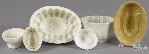 Six fruit-form food molds, to include a pineapple, a pear, etc., largest - 4'' h., 7 3/4'' w.
