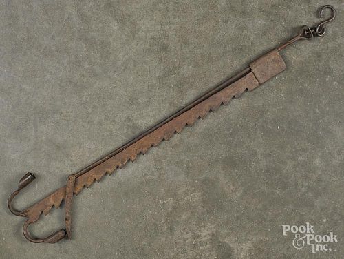 Wrought iron saw-toothed trammel, 19th c., with a double taperstick base, 22'' h.