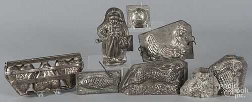 Eight tinned sheet iron molds, to include a hen, a rabbit, a fish, etc.