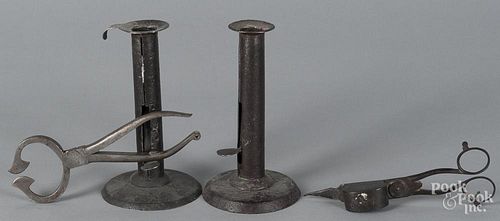 Two hogscraper candlesticks, 6 1/4'' h., together with sugar nippers and a scissor snuffer.