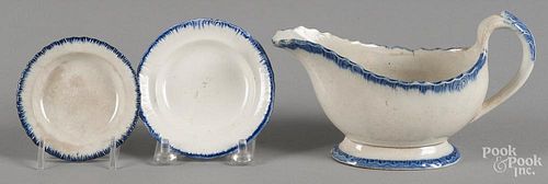 Pearlware blue feather edge creamer and two cup plates, 19th c.
