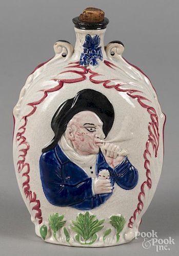 Pearlware bottle or flask, 19th c., with relief decoration of a man smoking a pipe, 8 1/4'' h.