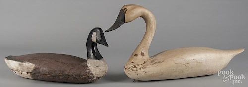 Carved and painted swan decoy, 15 1/2'' h., 31 1/2'' w., together with a Canada goose, 11 1/2'' h.