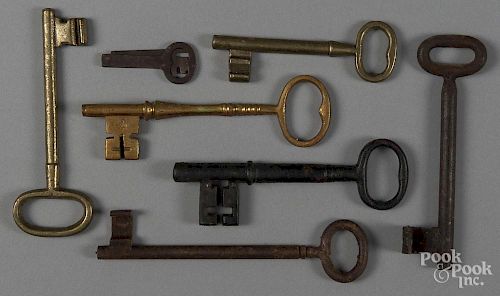 Seven antique brass and iron keys.