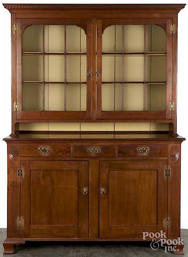 Pennsylvania walnut two-part Dutch cupboard, ca. 1800, with paterae and fluted pilasters.