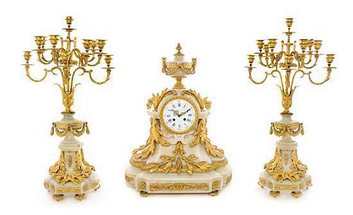 A Napoleon III Gilt Bronze and Onyx Clock Garniture Height of candelabra 30 1/2 inches.