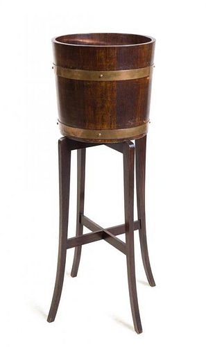 * A Regency Brass Banded Peat Bucket on Stand Height 41 1/2 x width 36 x depth 23 inches.
