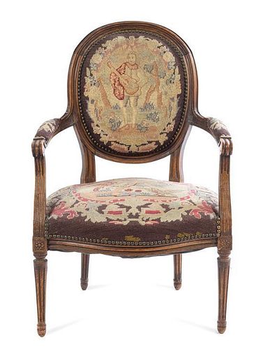 A French Carved Walnut Fauteuil Height 34 1/2 inches.