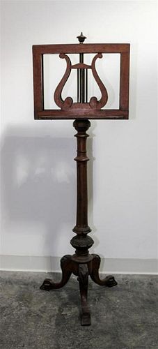 A Victorian Carved Mahogany Duet Stand Height 49 1/2 inches.