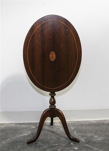 A Georgian Style Mahogany Tilt-Top Table. Height 22 1/2 x width 19 x depth 14 inches.