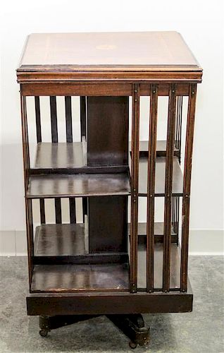 A Walnut Revolving Bookcase. Height 33 x width 18 x depth 18 inches.