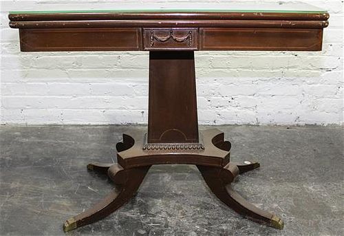A Duncan Phyfe Style Mahogany Flip-Top Table. Height 27 1/2 x width 35 x depth 18 inches.