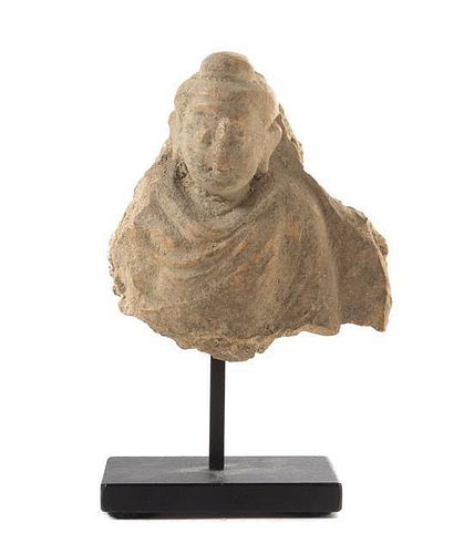 * A Small Gandharan Stucco Fragment Height 2 1/2 inches.
