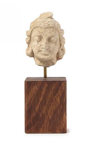 * A Gandharan Stucco Head of a Warrior Height 2 inches.