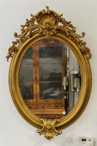 * A Napoleon III Giltwood Mirror Height 39 inches.