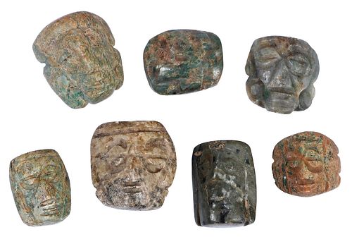 Seven Mesoamerican Carved Jade Mask Pendants