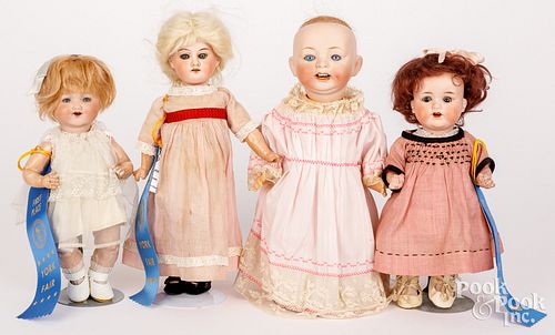 Four small bisque head dolls