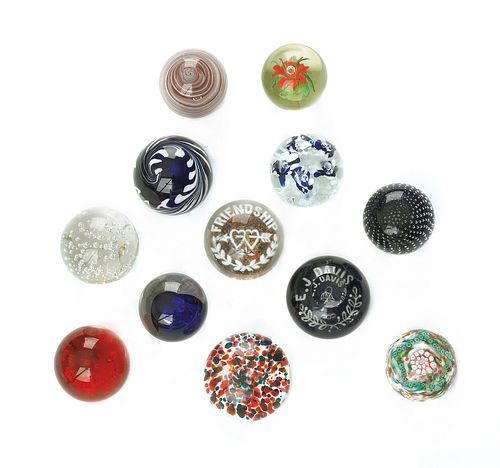 Collection of twelve glass paperweights.