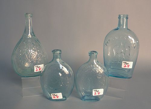 Four aqua glass bottles.