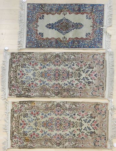 Three Kirman mats, 4' 4" x 2' (2) and 3' 6" x 2'.