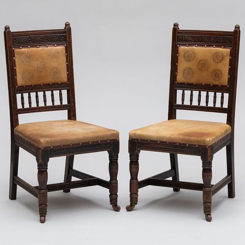 Pair of English Aesthetic Movement Carved Oak and Leather Side Chairs, designed by E.W. Godwin