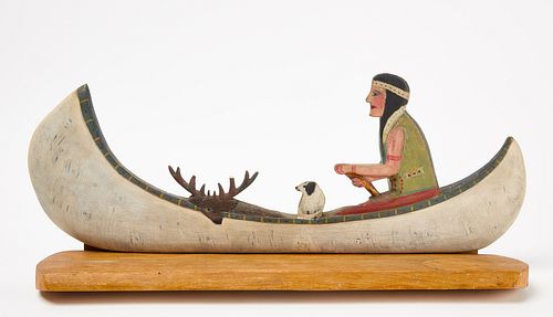 Wood Carving of Native in a Canoe