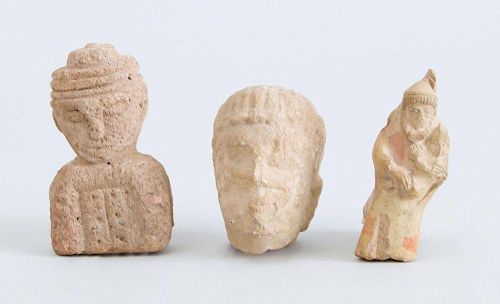 TWO CARVED STONE FIGURAL FRAGMENTS