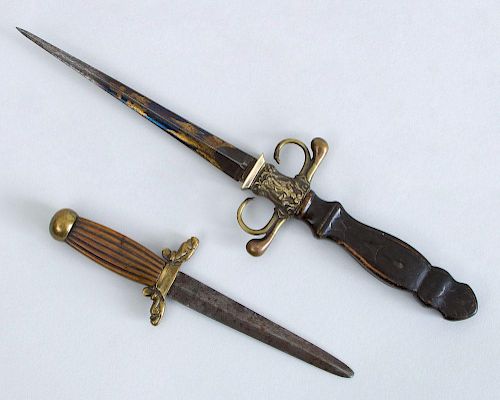 TWO DECORATIVE BRASS-MOUNTED WOOD AND METAL DAGGERS