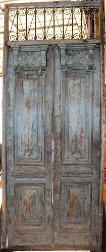 Pair of carved wood & iron entry doors with transom.