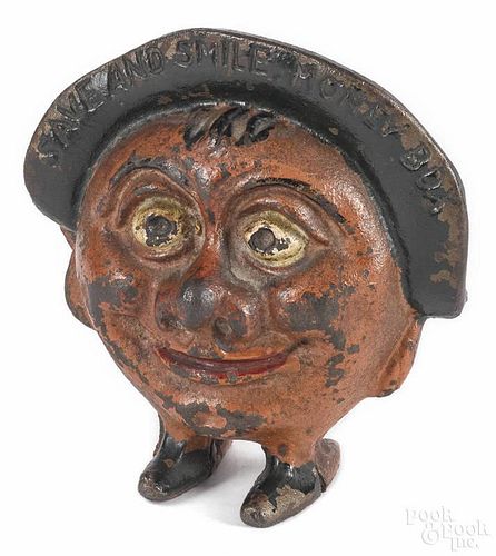 Cast iron Save and Smile Money Box still bank, 4 1/4'' h.