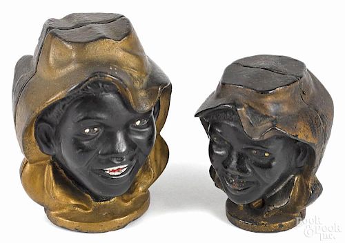 Two cast iron double black face still banks, 4'' h. and 3 1/4'' h.