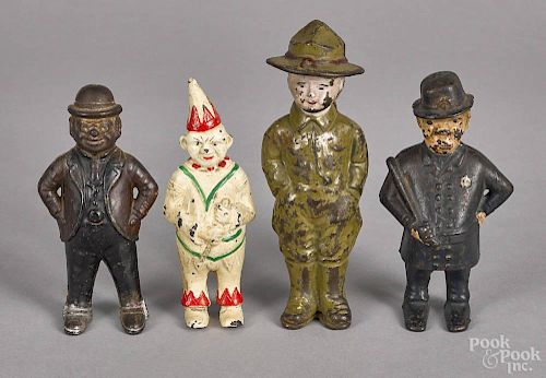 Four cast iron still banks, to include a doughboy, a Foxy Grandpa, a clown, and a Mulligan the cop
