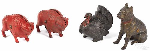 Four cast iron still banks, to include two buffalos, a turkey, and a seated dog, tallest - 4 1/2''.